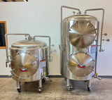 Two stainless steel Blue Myco Autoclaves on casters, one smaller and one larger, photographed indoors against a plain wall.