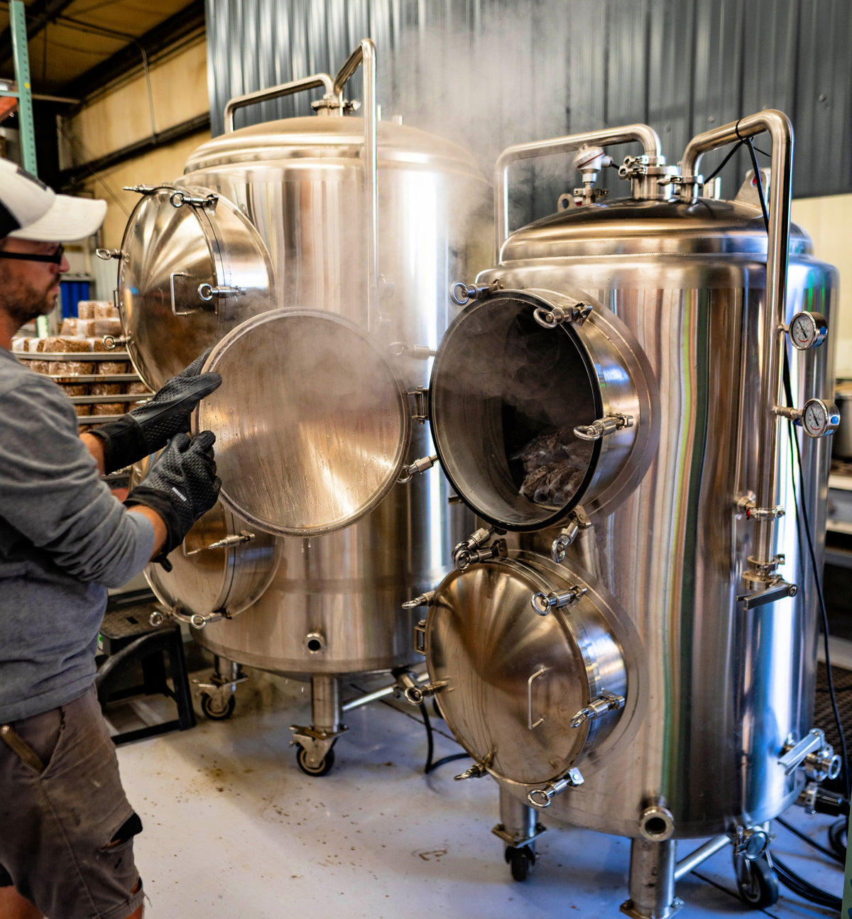 a person unloading a blue myco 310L autoclave with steam coming out